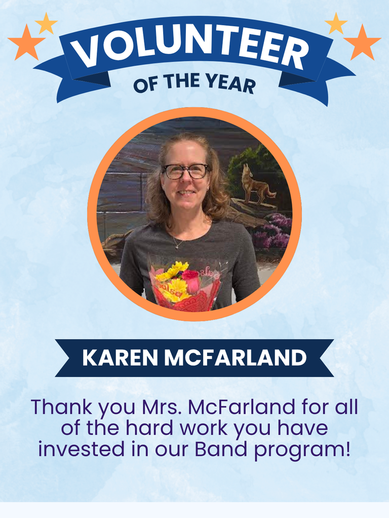 Mrs. Mcfarland with flowers in front of a blue background.