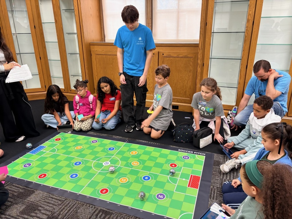 students sitting around a gaming board