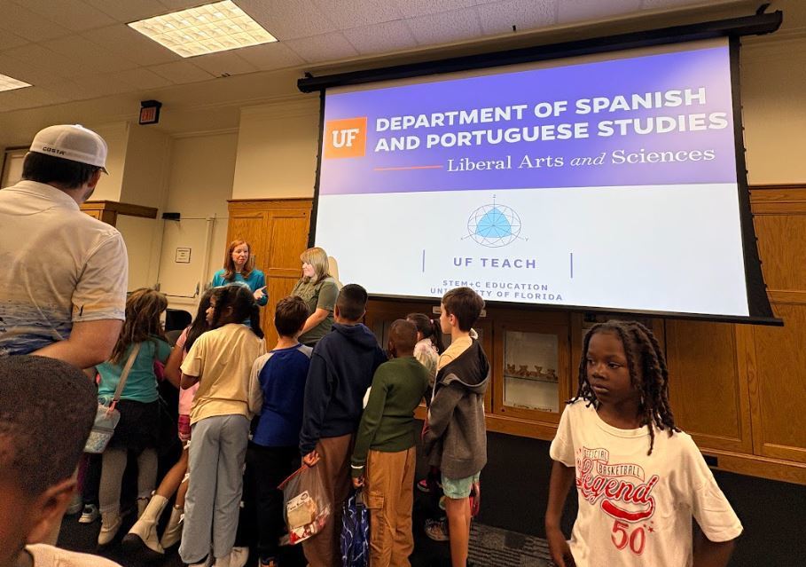 students listening to a presentation in front of a screen