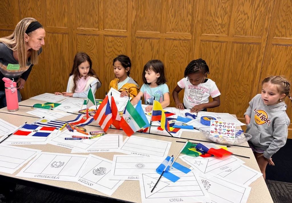 students at a table learning about flags
