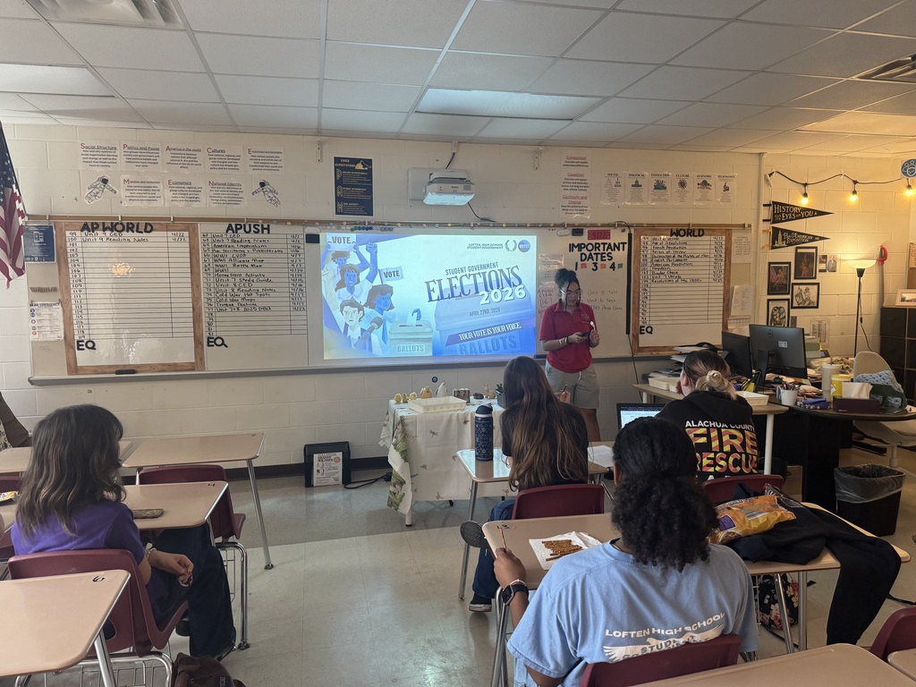 student stands next to project display that says "elections 2026"