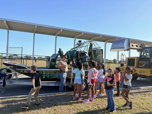 student in front of an airboat