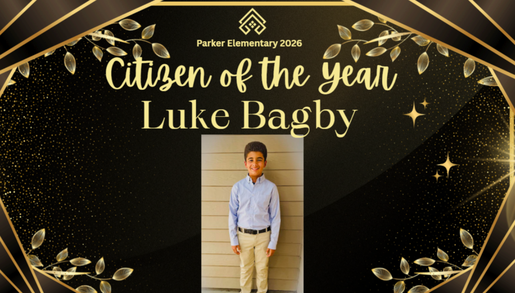 Student standing in front of a wall with words citizen of the year