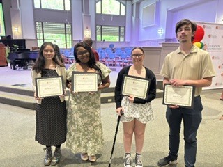 4 students hold scholarship certificates