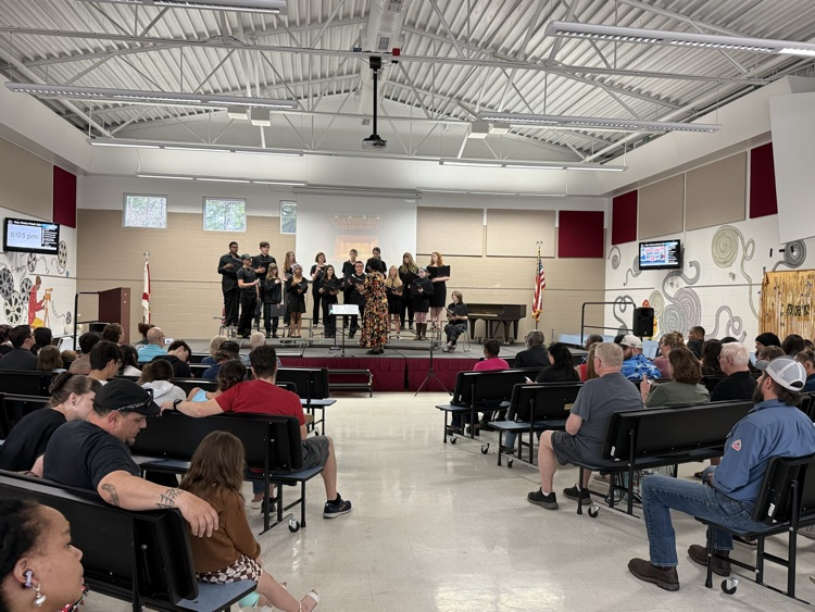 students sing on a stage