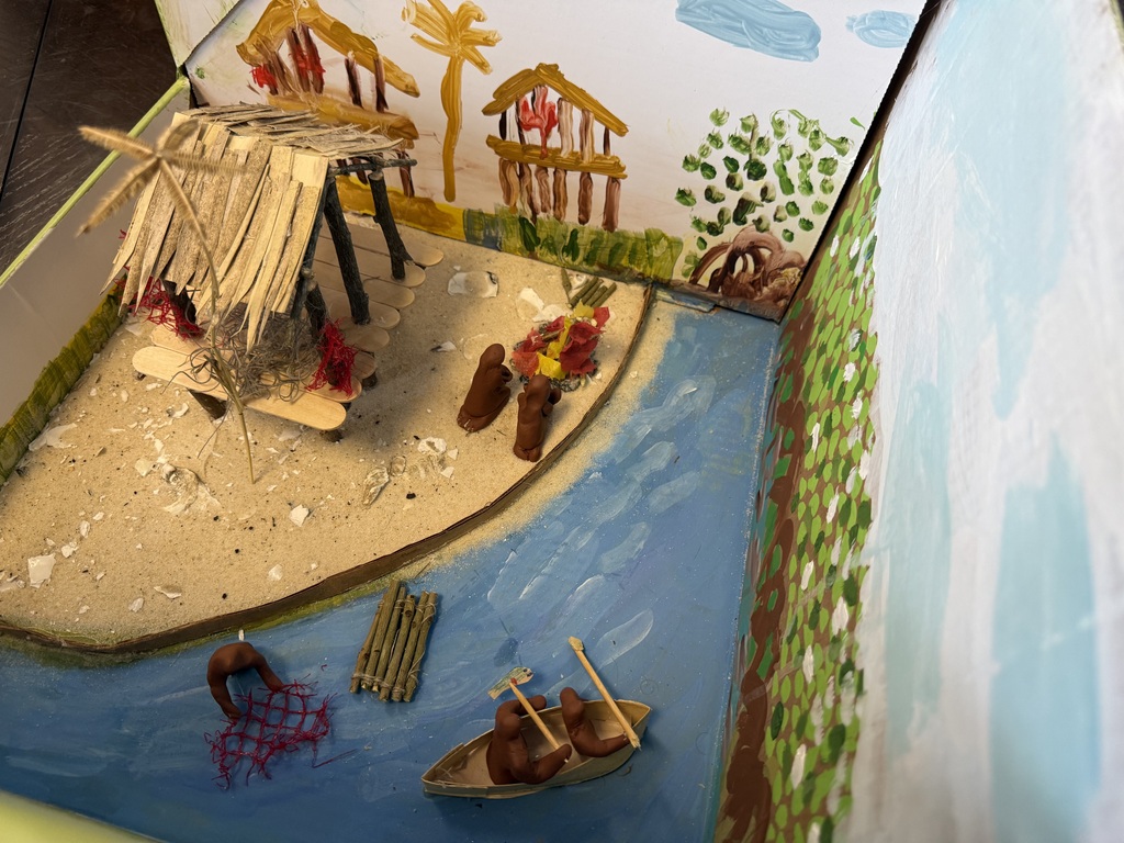 Native American Diorama with household objects depicting huts, water, hay, animals.