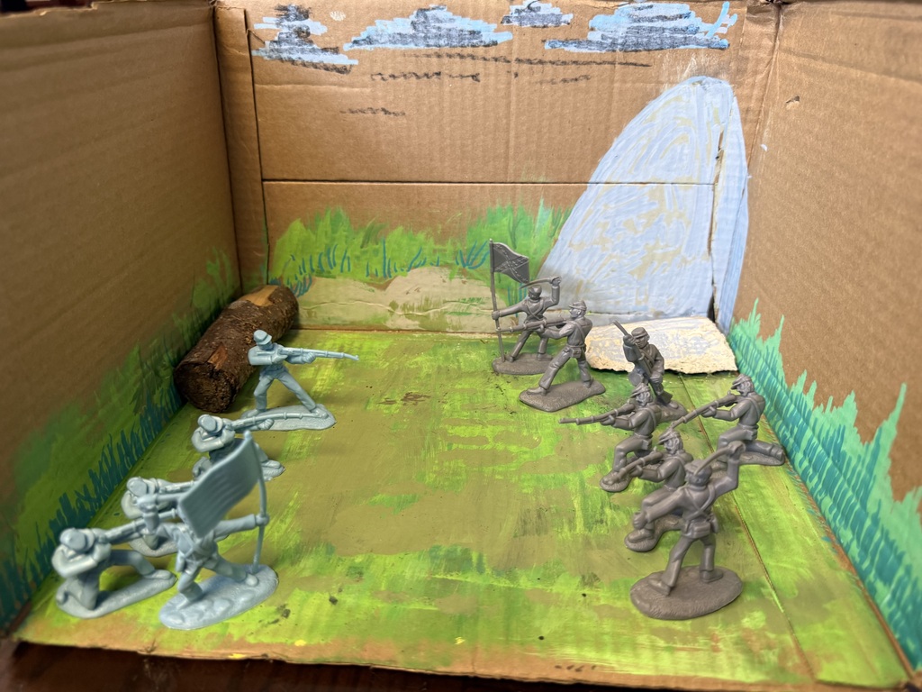 Native American Diorama with household objects depicting huts, water, hay, animals.