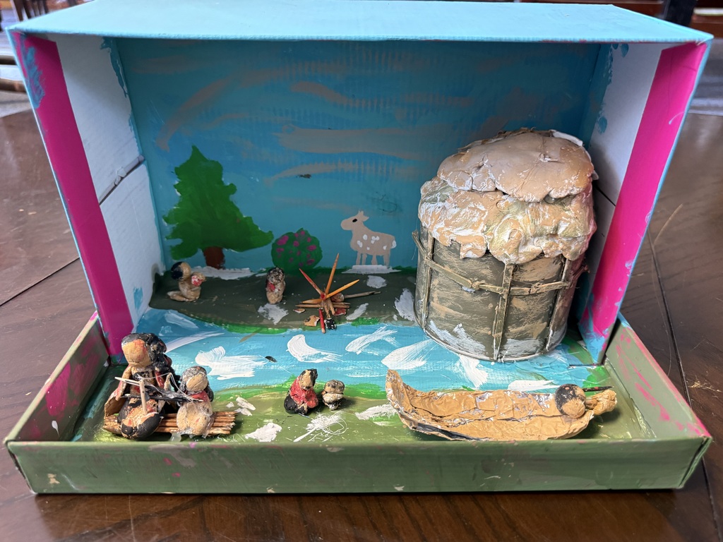 Native American Diorama with household objects depicting huts, water, hay, animals.
