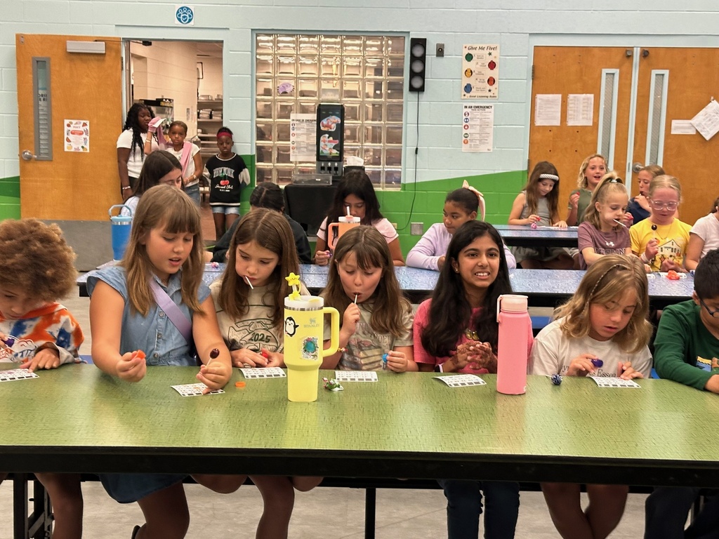 Kids hold up prizes won at the PBIS bingo game today.