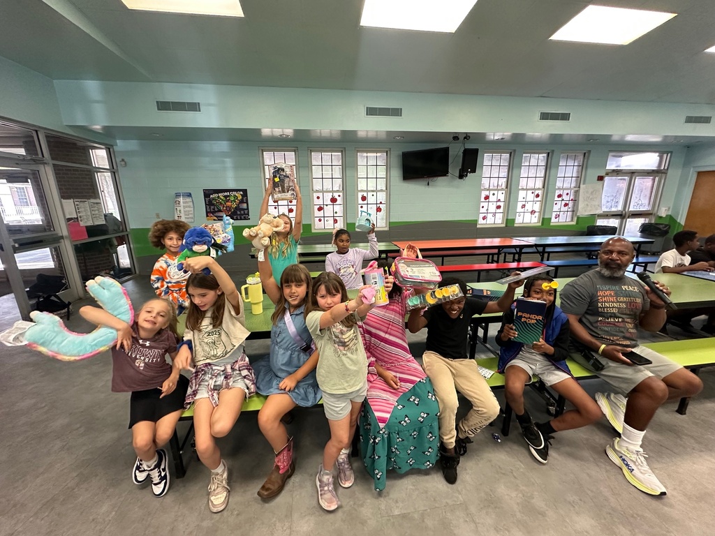 Kids hold up prizes won at the PBIS bingo game today.