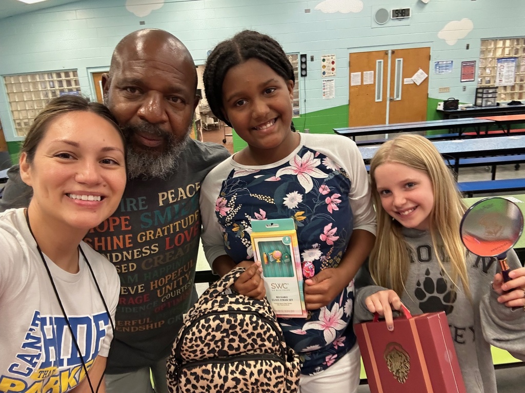 Kids hold up prizes won at the PBIS bingo game today.