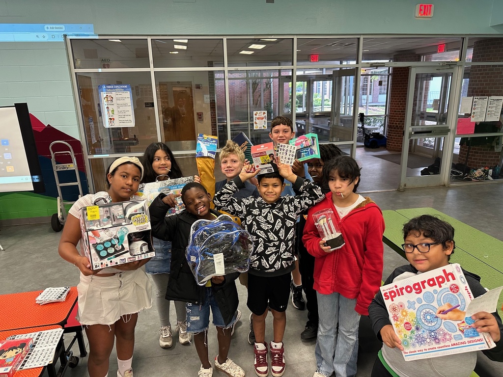 Kids hold up prizes won at the PBIS bingo game today.