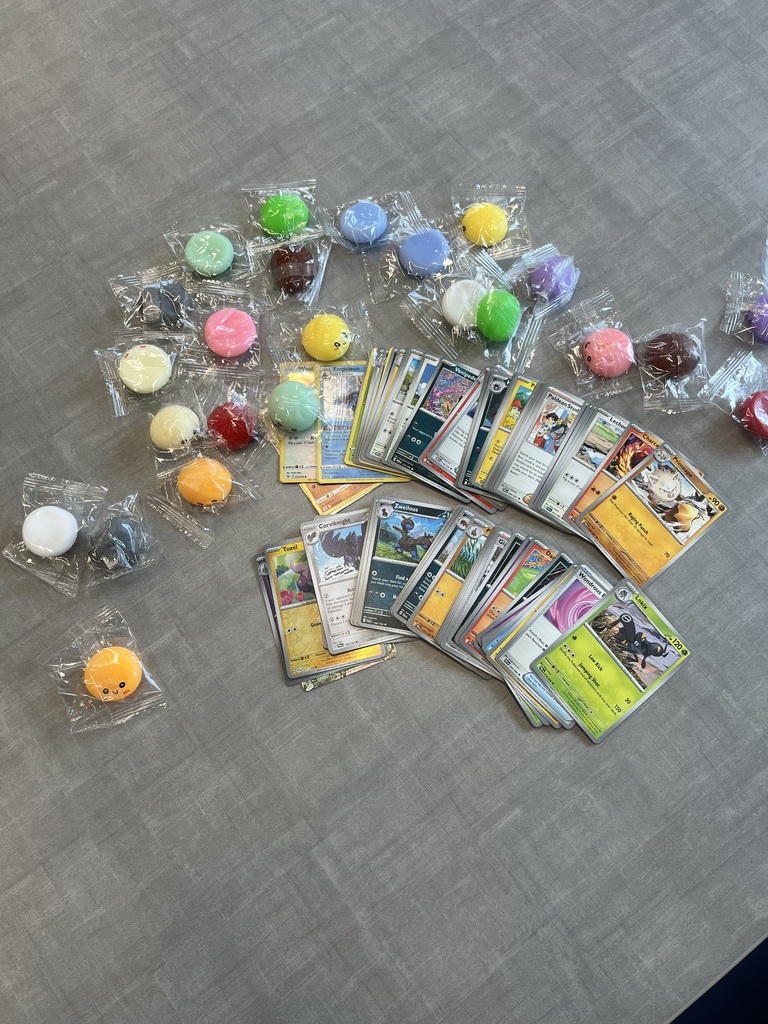 picture of pokemon cards and various colored fidgets