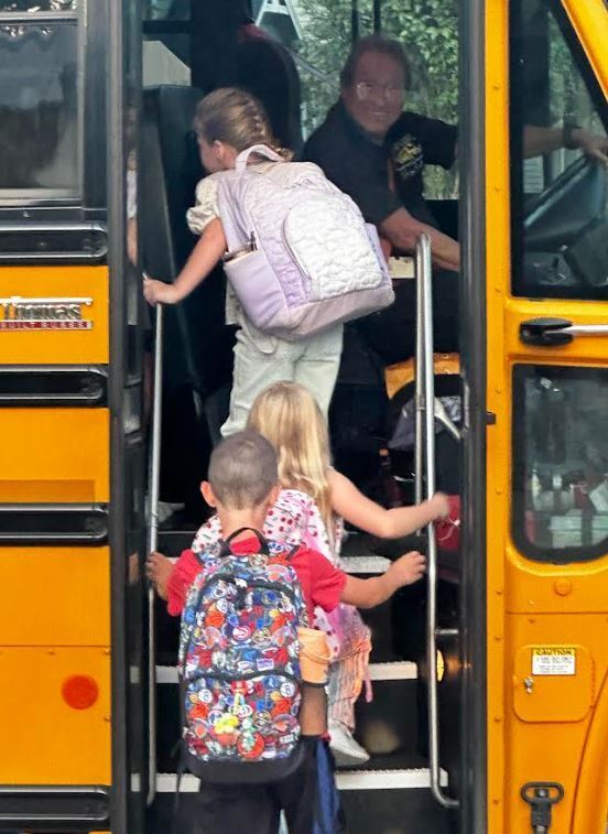 kids getting onto a bus