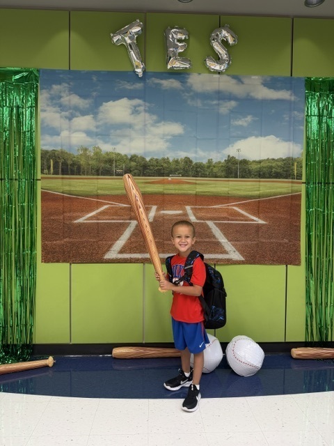 kid posing with toy bat