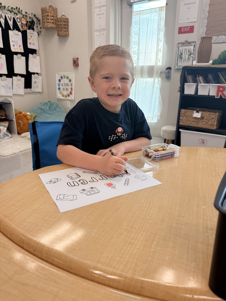 kid at a desk coloring