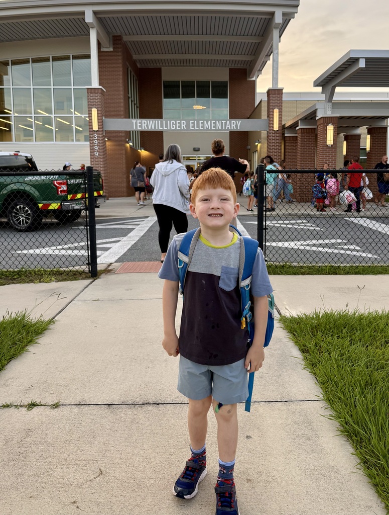 Student in front of school