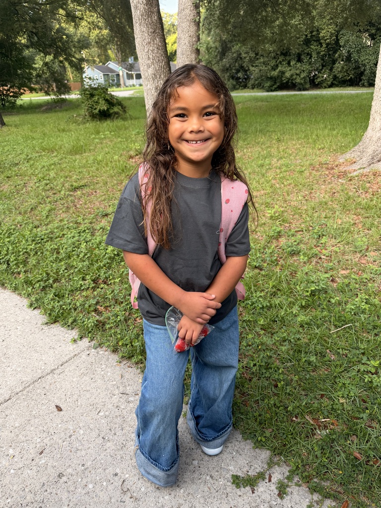 student smiling with backpack