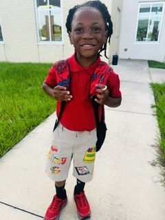 student in red smiling