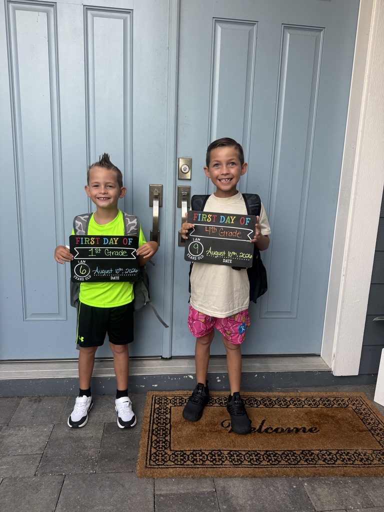 two boys in front of a blue door