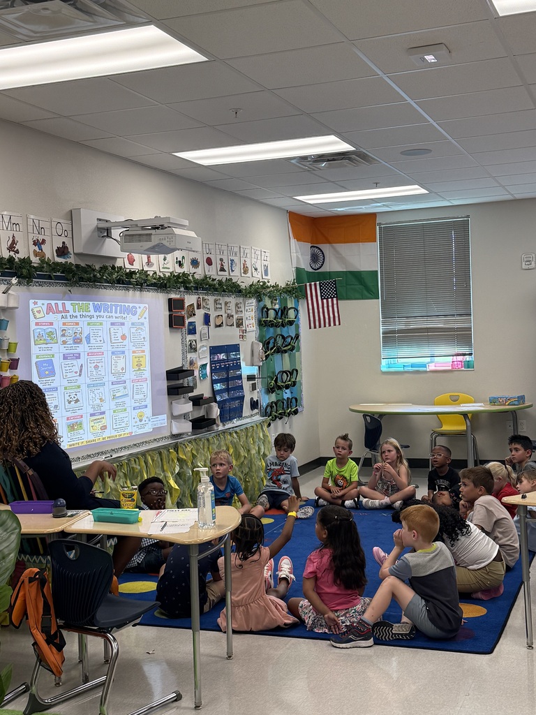 students on the carpet listening to the teacher