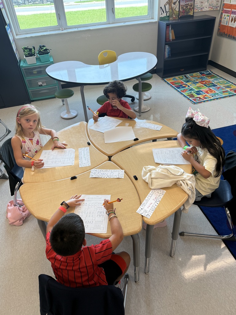 four students working at desks