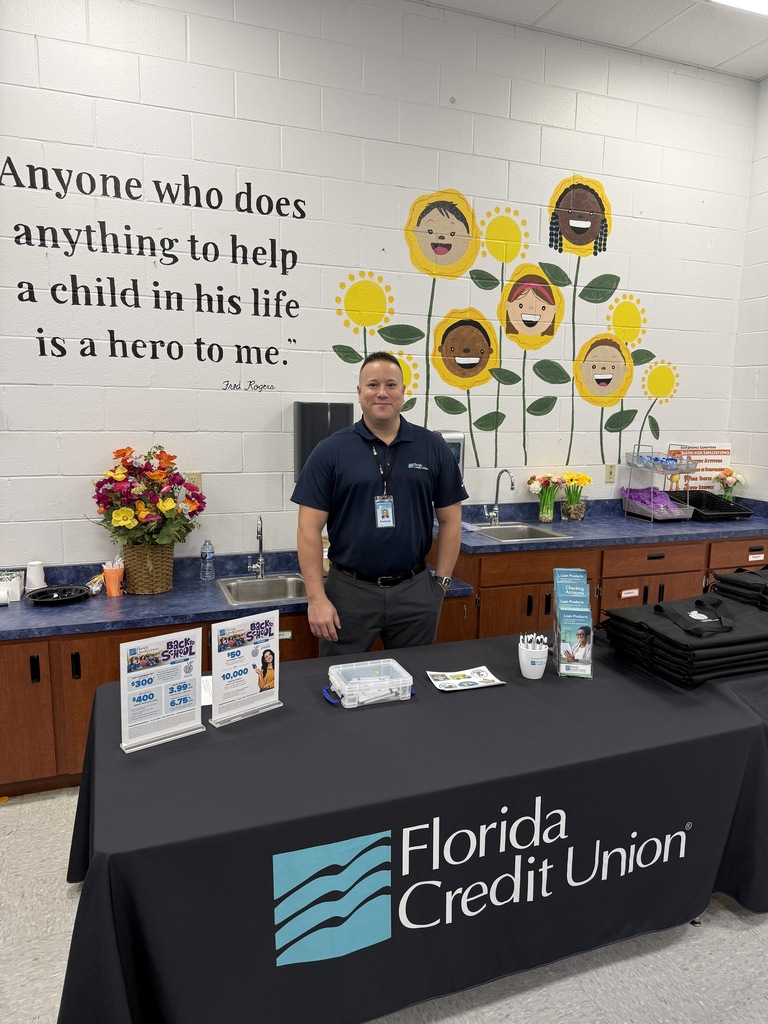 Florida Credit Union employee standing with swag for teachers.