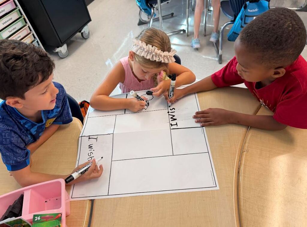 three students at a desk