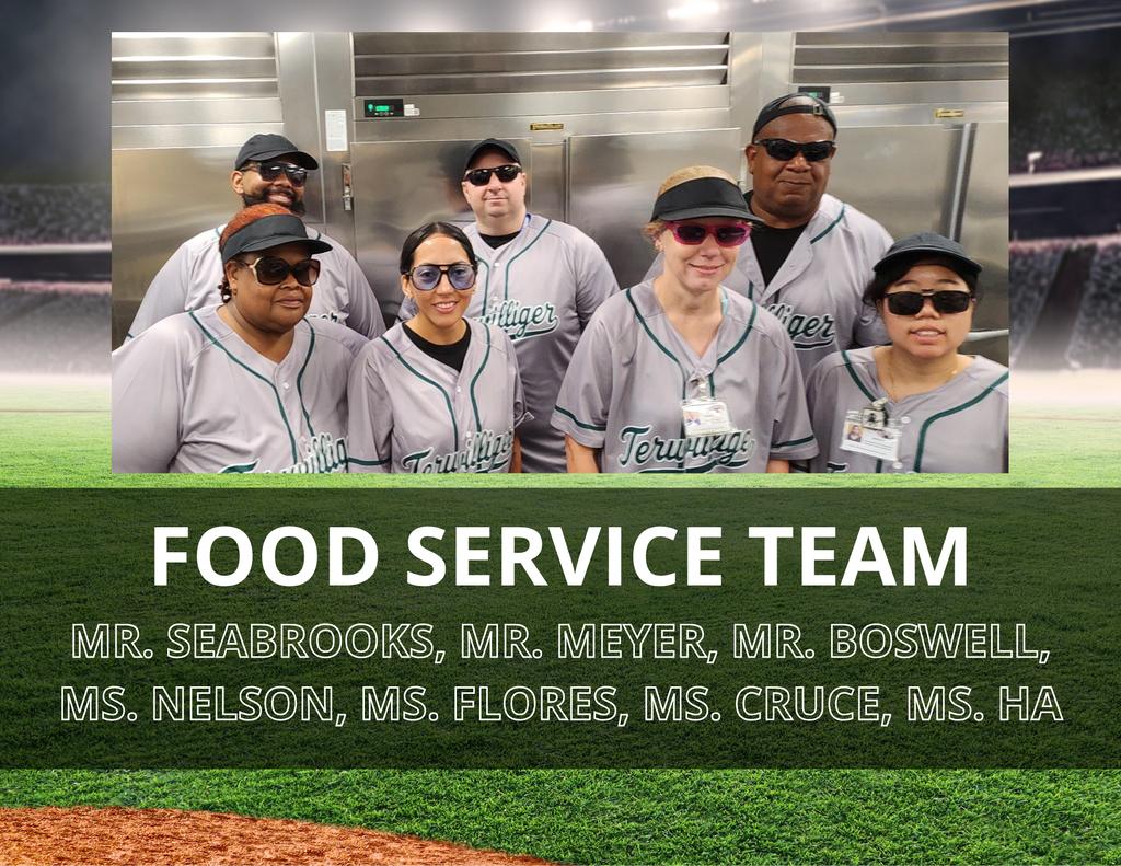 employees in jerseys, sunglasses smiling in a kitchen