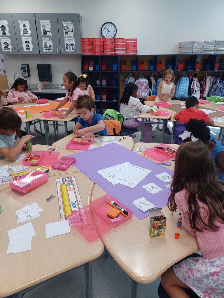 classroom of students working on purple posters