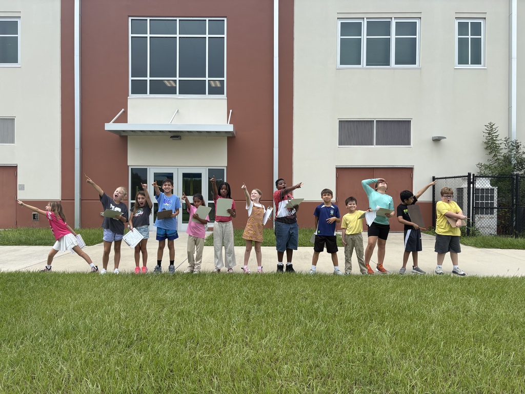 students standing outside pointing