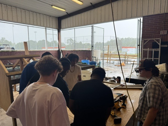 Construction students working on building