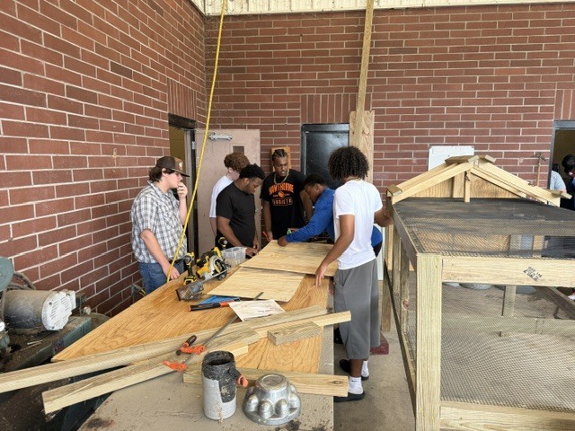Construction students working on building