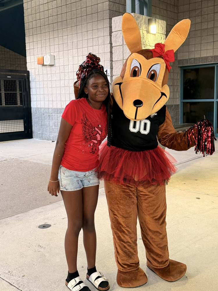 coyote mascot with a female student