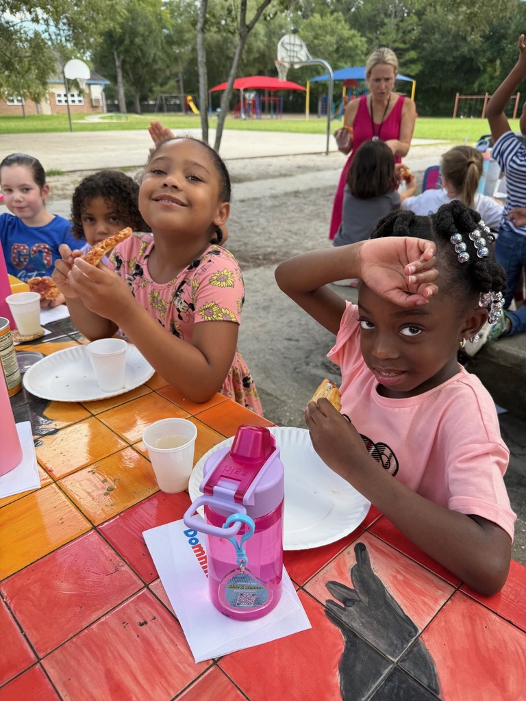 A first grade class celebrates earning the most from Boosterthon with a class pizza party