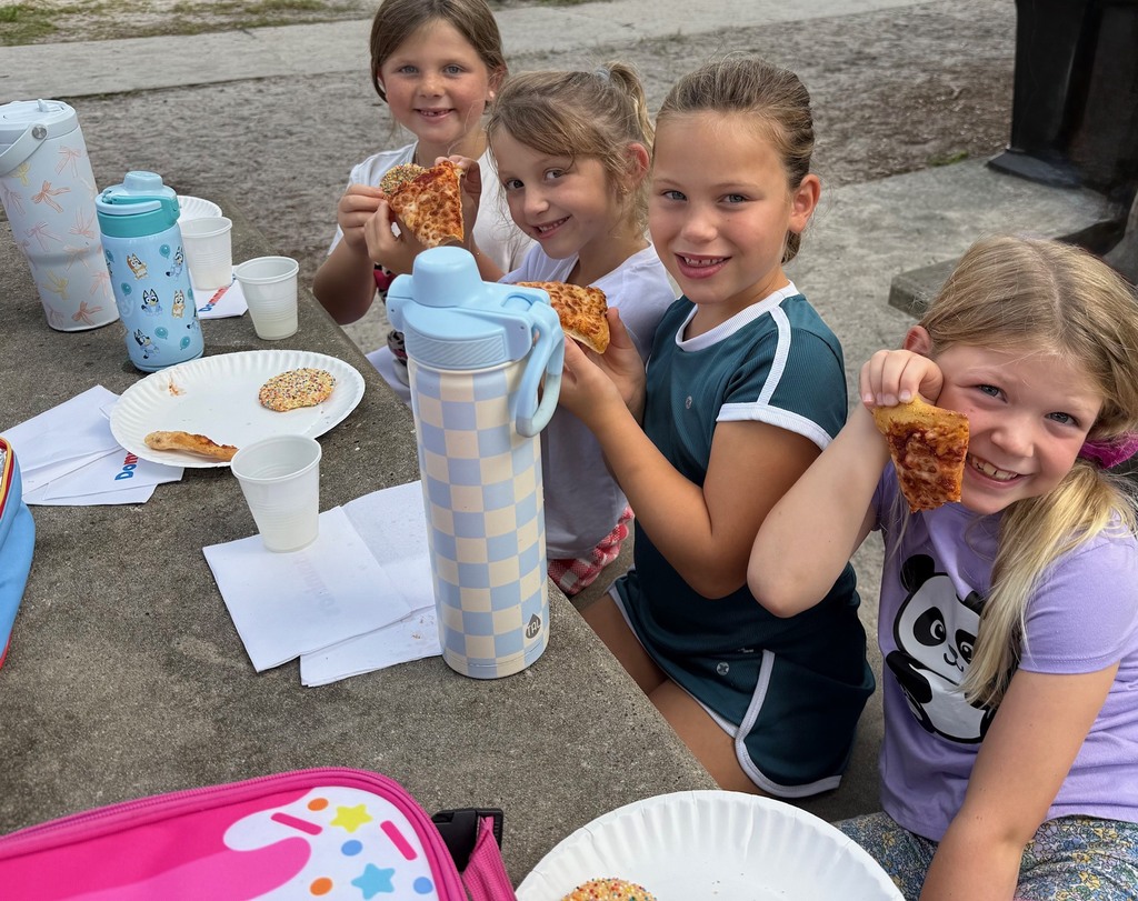 A first grade class celebrates earning the most from Boosterthon with a class pizza party