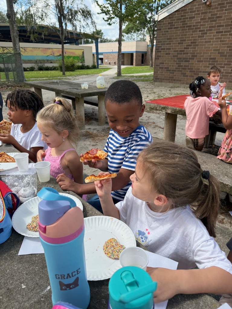 A first grade class celebrates earning the most from Boosterthon with a class pizza party