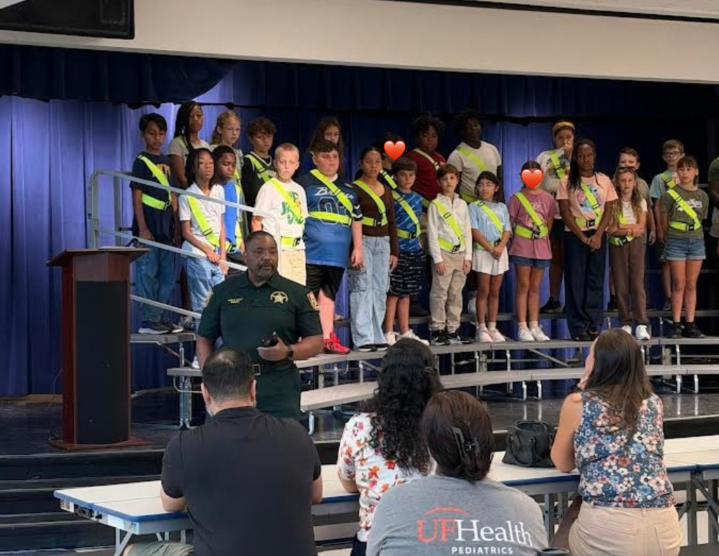 student on a stage with Sheriff in the front