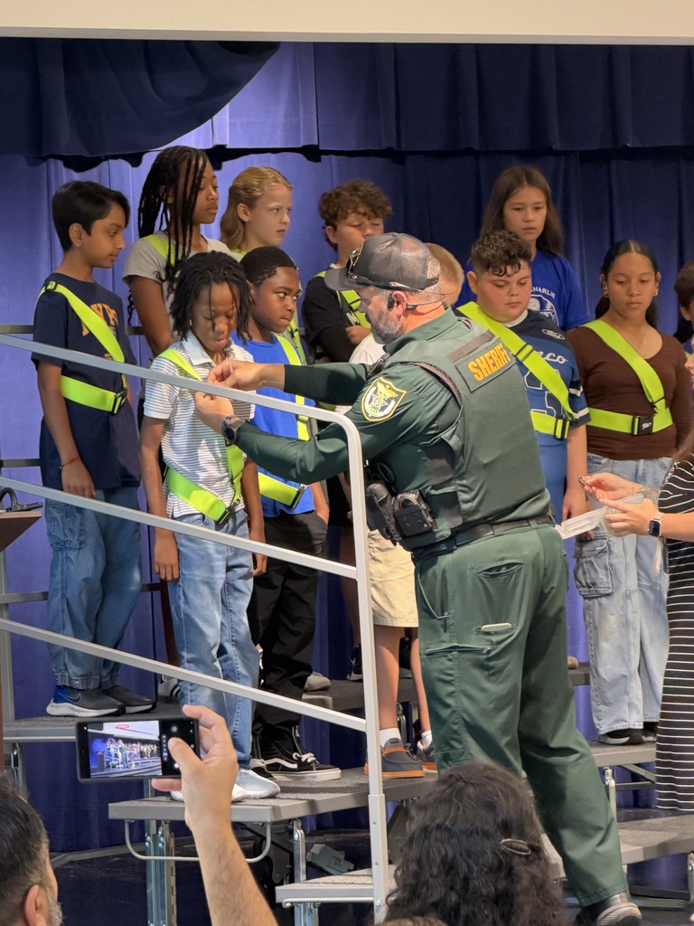 patrols on a stage with deputy putting a pin on them