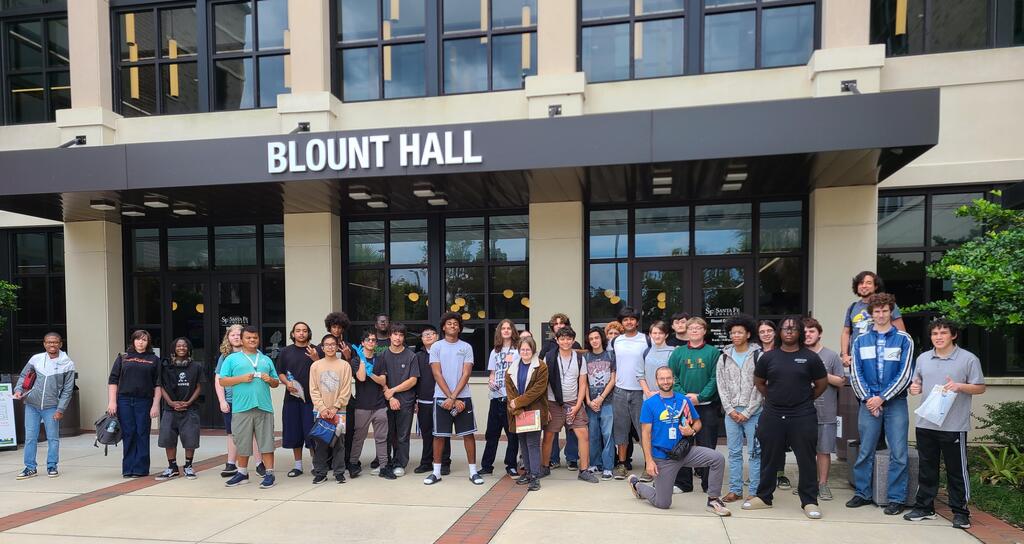 Students and teachers stand in front of Blount Hall