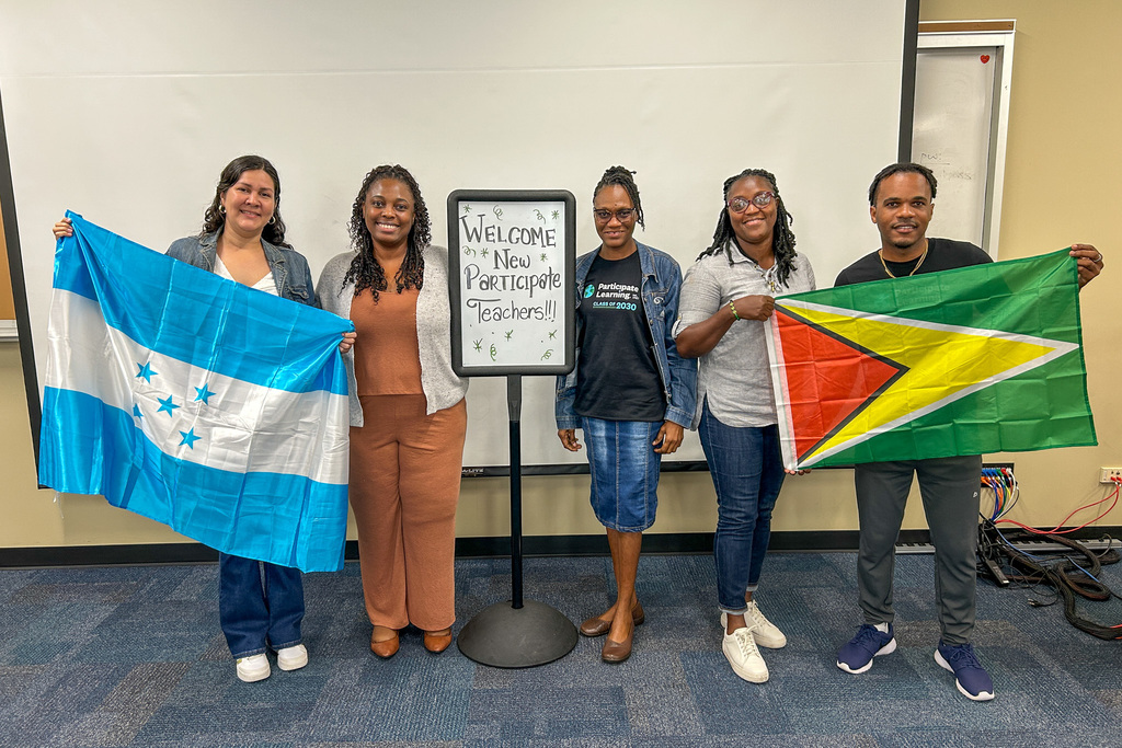 New teachers from Honduras, Jamaica, and Guyana, with the Honduran and Guyana flag displayed
