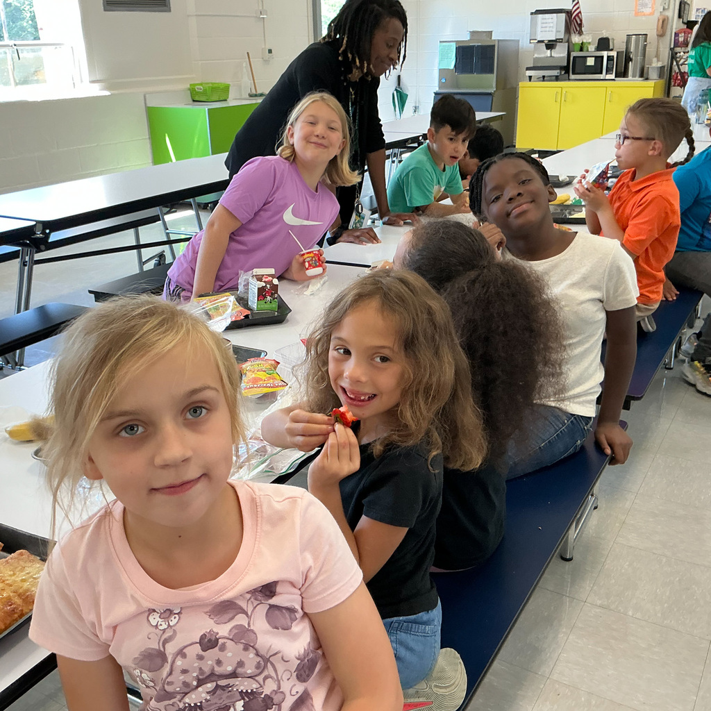 Elementary students enjoy a lunch in a school cafeteria