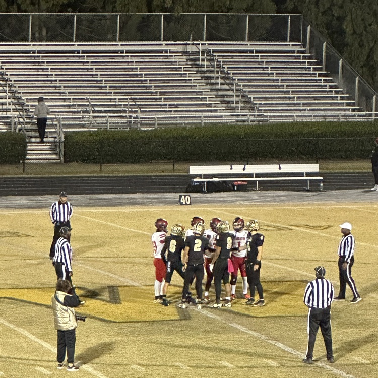 team captains and referees on the field for the coin toss
