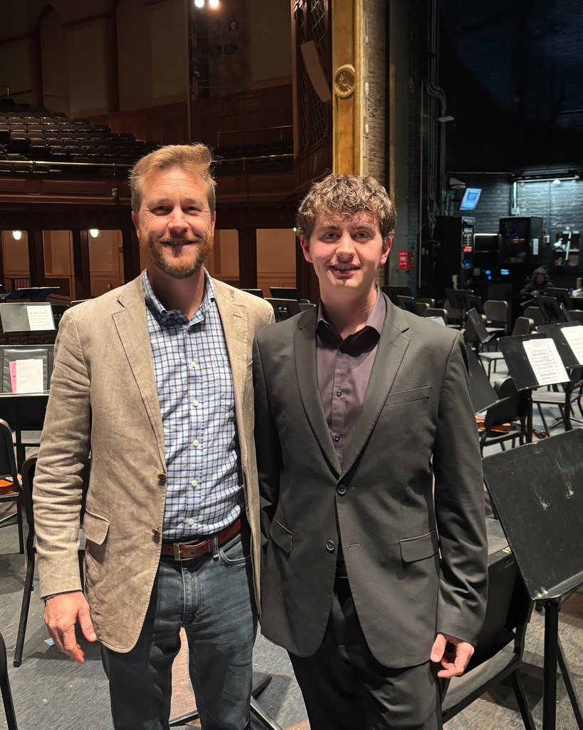 Photo of Christian Boudreault with Band Director Michael Jefferson on stage