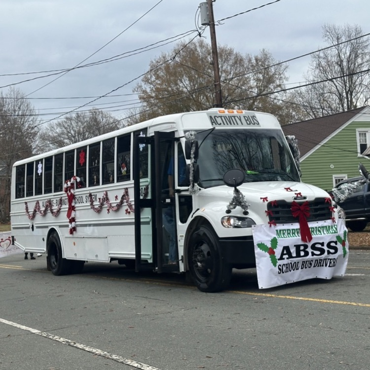 white activity bus with sign from ABSS bus drivers 