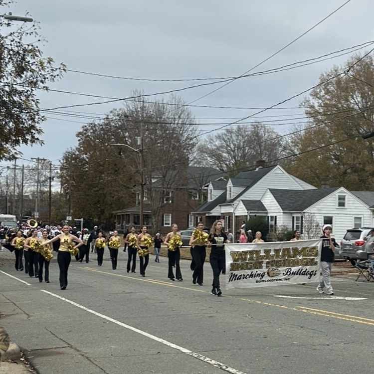 banner in front of dance team members 