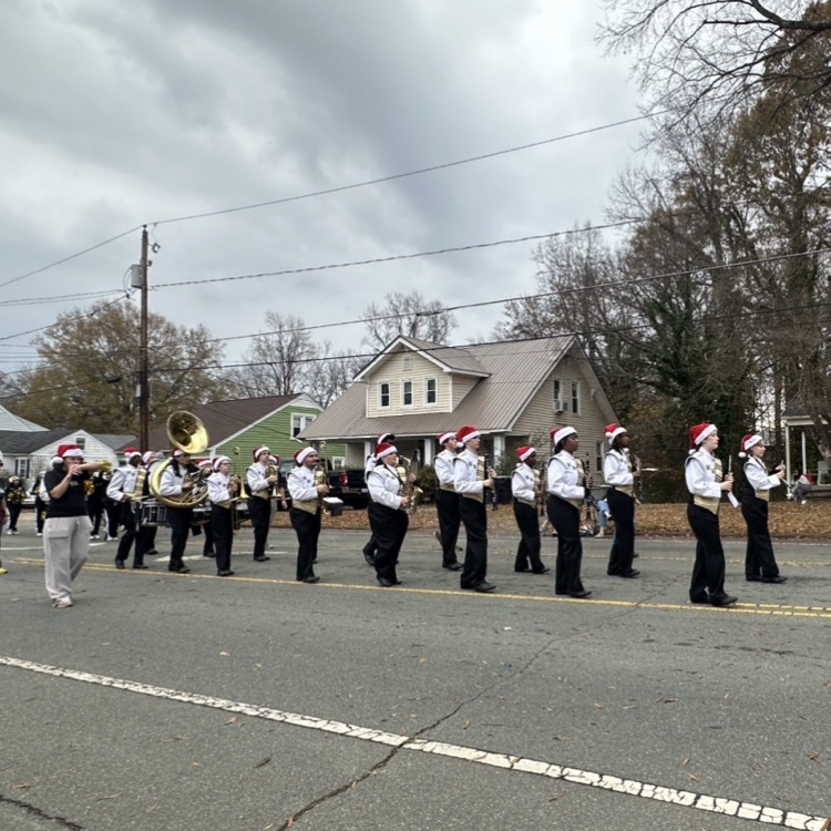 marching band walking on a street 