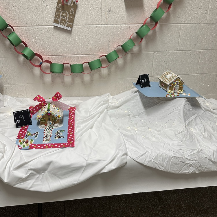 two gingerbread houses on white snowy background