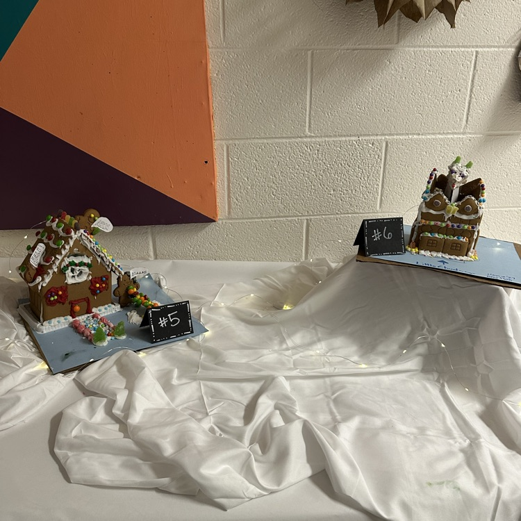 two gingerbread houses on white snowy background
