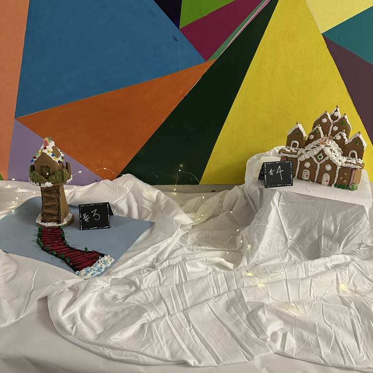 two gingerbread houses on white snowy background